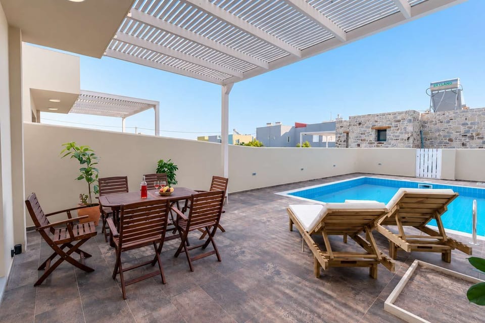 Spacious rooftop terrace with outdoor dining and sun loungers.