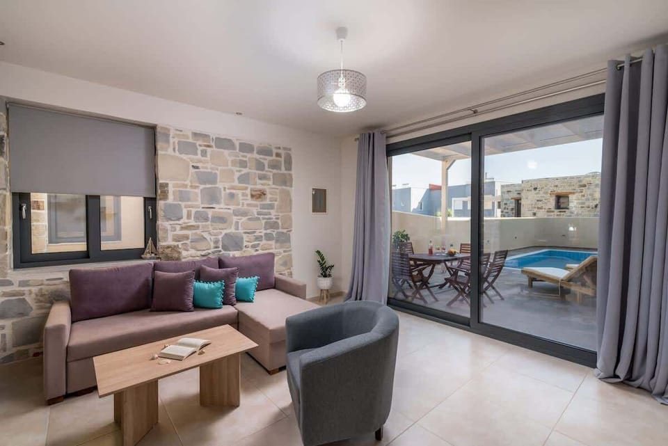 Bright open-plan living room with direct access to the pool terrace.