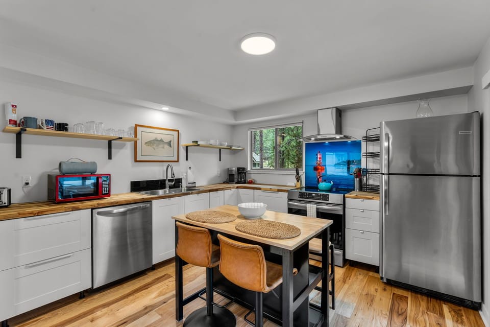 Gather with loved ones in your fully-equipped kitchen, where warm wood countertops and modern stainless appliances invite you to cook, share meals, and create lasting memories together.