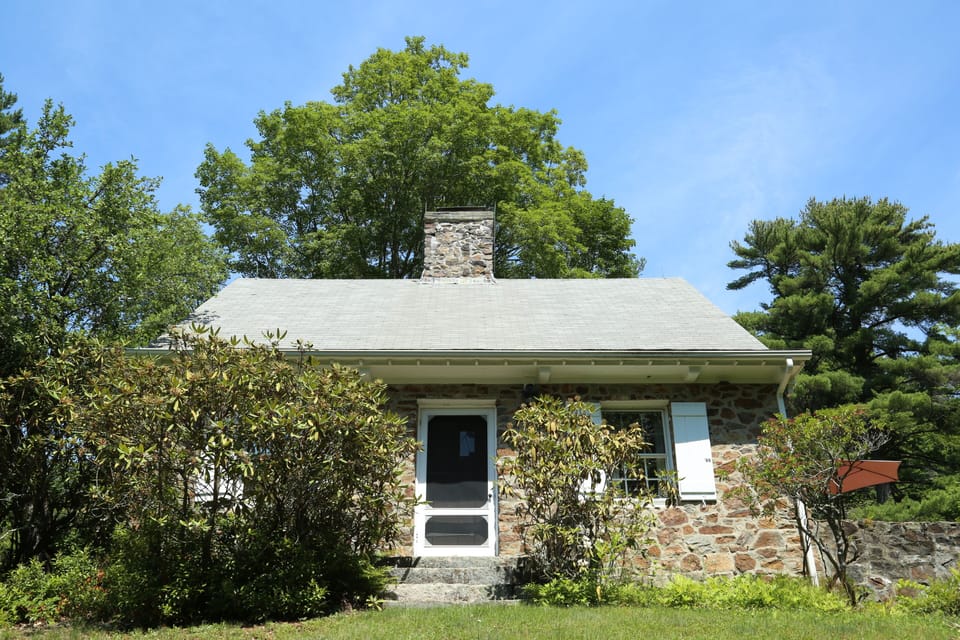 Charming stone cottage featuring rustic masonry walls