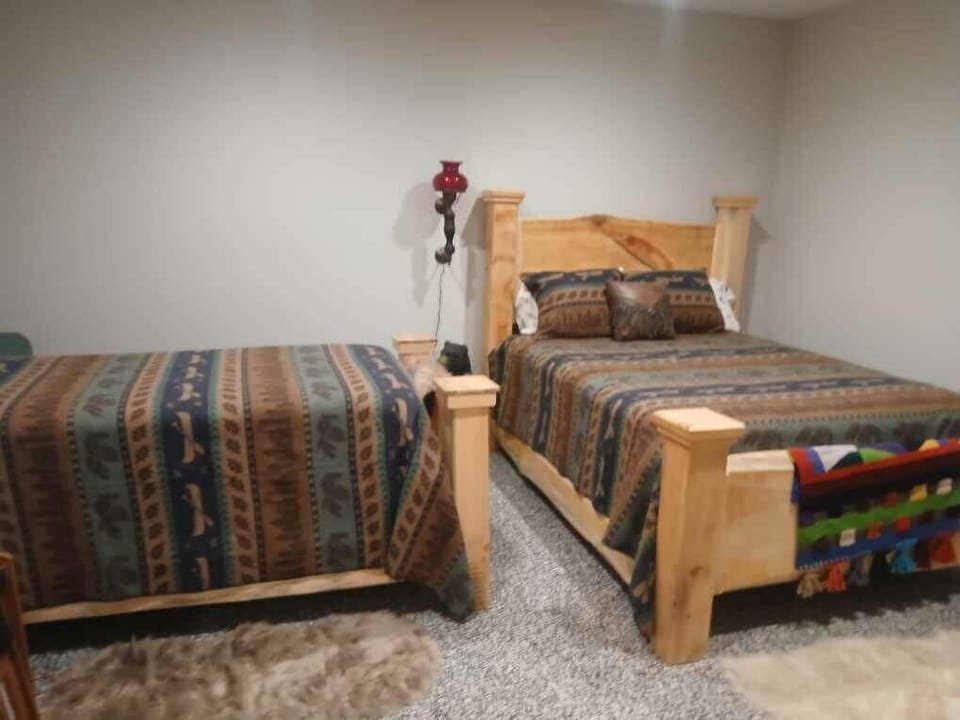 Cozy rustic bedroom with two wood beds, ideal for families or friends