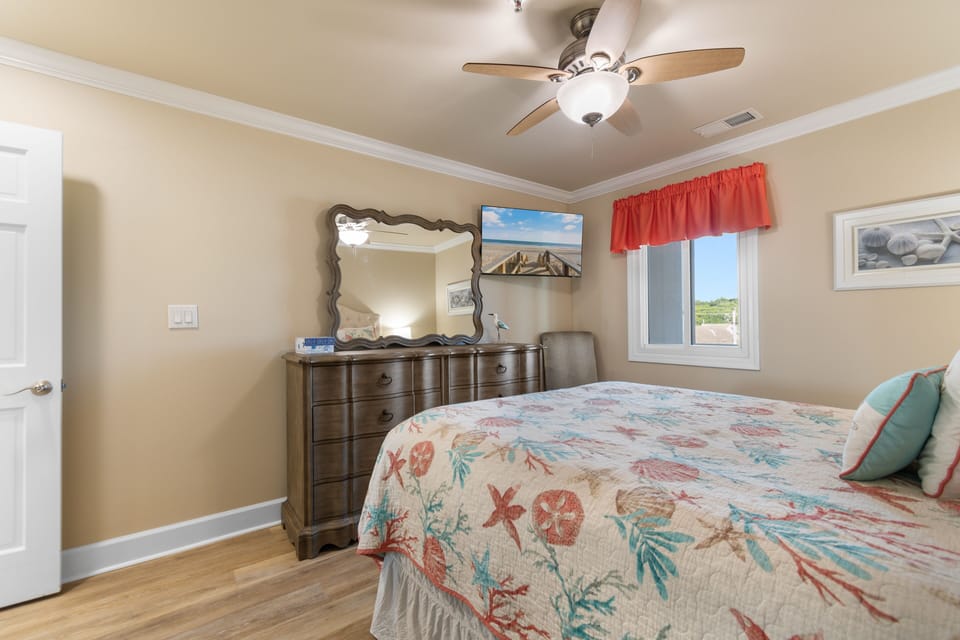 Guest bedroom with ceiling fan, dresser, and window with garden view, Surfwatch 3 Unit 305, Surfside Beach