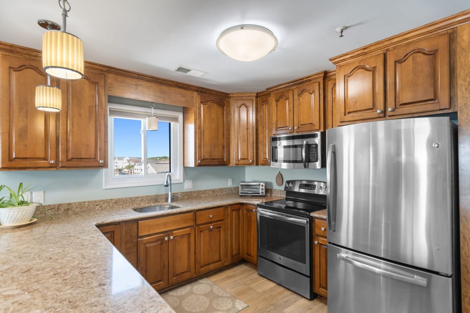 Fully equipped kitchen with stainless appliances, wood cabinetry, and granite countertops, Surfwatch 3 Unit 305, Surfside Beach