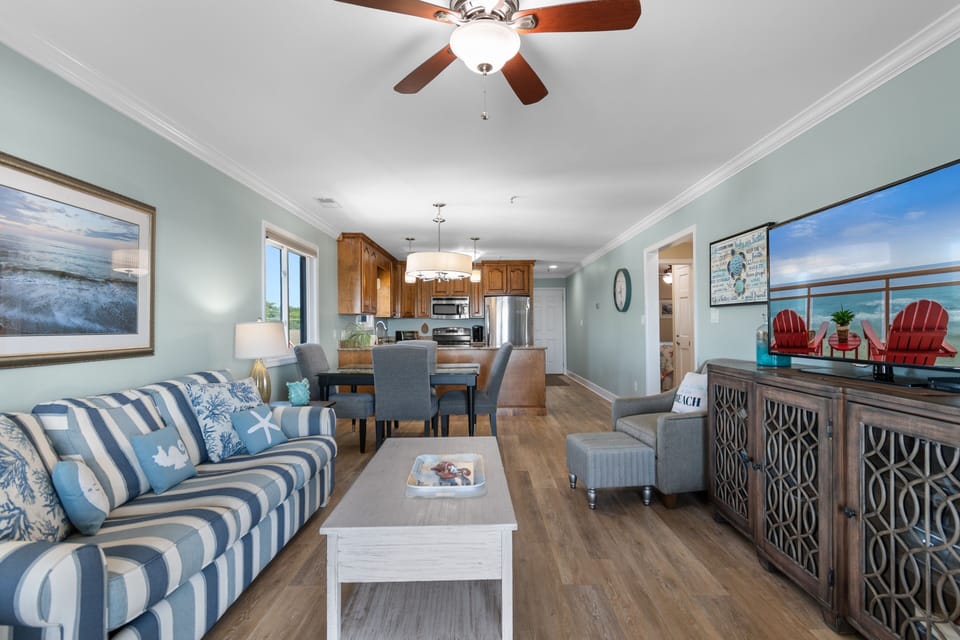 Living room with flat-screen TV, coastal décor, open to dining and kitchen, Surfwatch 3 Unit 305, Surfside Beach