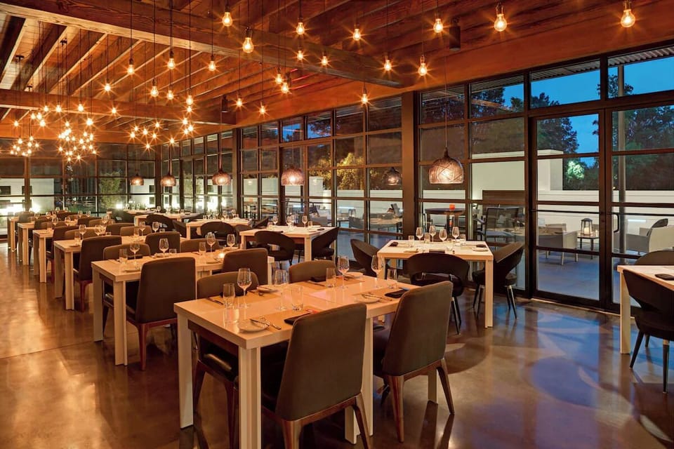 Linger over evening bites beneath warm, twinkling pendant lights.