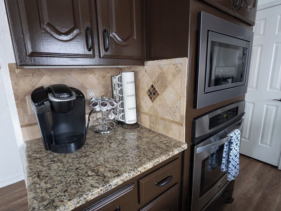 Keurig coffee maker with complimentary coffee pods & mugs for your convenience.