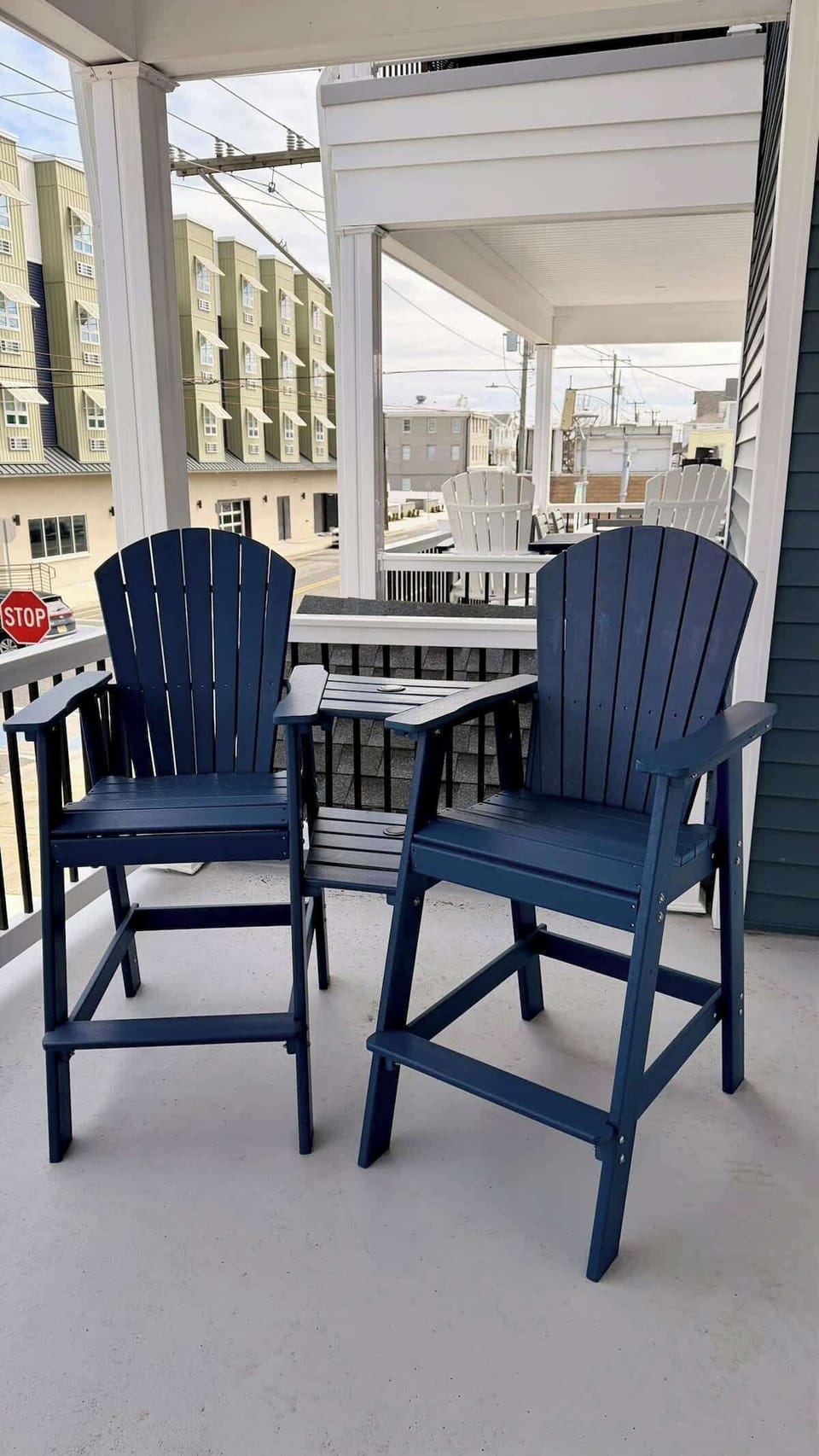 Relax on the covered balcony with comfortable seating, the perfect spot to enjoy fresh air and coastal breezes.