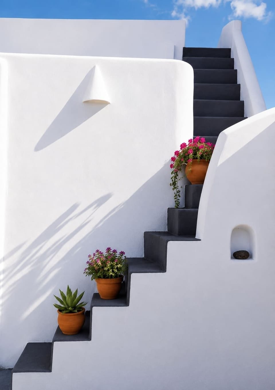 Traditional whitewashed stairway with flowers and classic Santorini architecture.