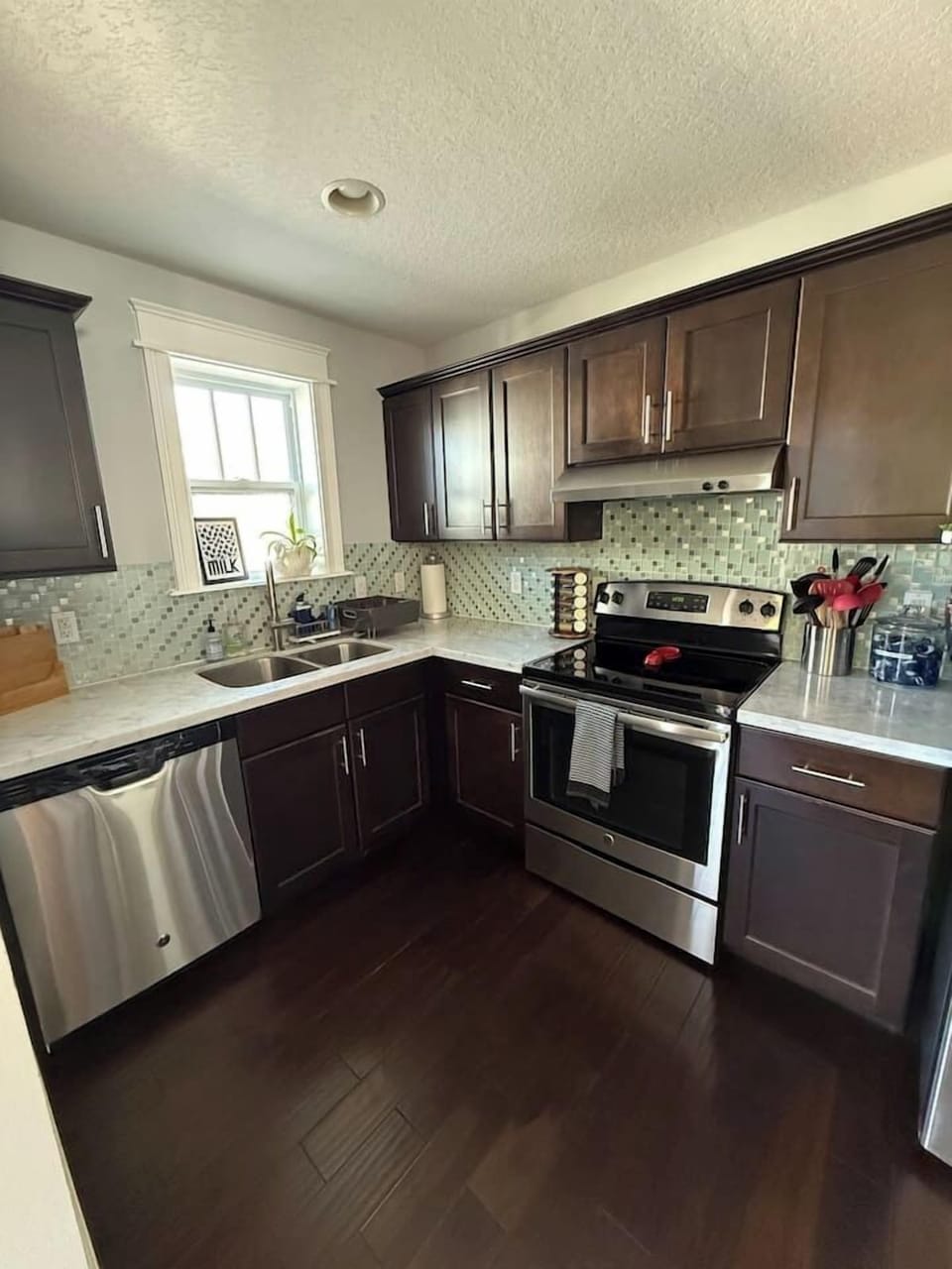 Full size kitchen with an oven/stove, refrigerator, and dishwasher. All kitchen essentials stocked in the cabinets. There’s also a microwave, toaster, tea kettle, coffee maker, Keurig machine and toaster oven.