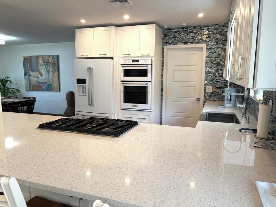 Bright modern kitchen with huge island and high-end appliances