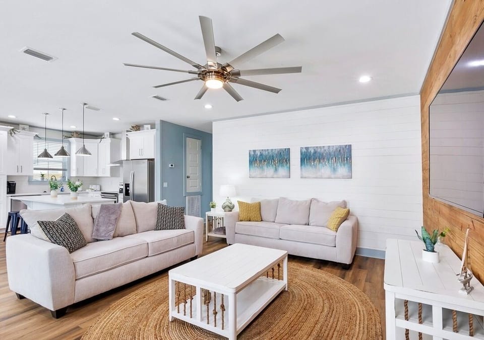 1st Floor - Spacious open-concept living room with comfortable seating for the whole group and a large 4K Smart TV—perfect for relaxing together after a day at the beach!