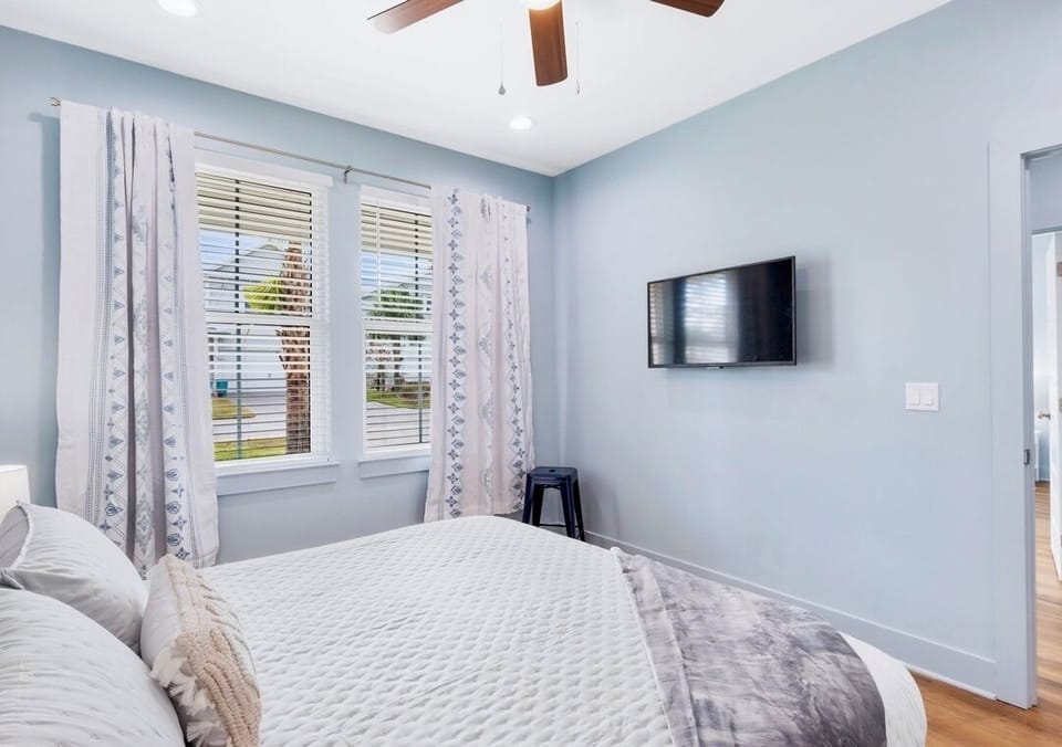 1st Floor - King Suite #1 features a comfortable King bed, 4K Smart TV, and en-suite bathroom with a shower/tub combination—perfect for relaxing after a day at the beach!