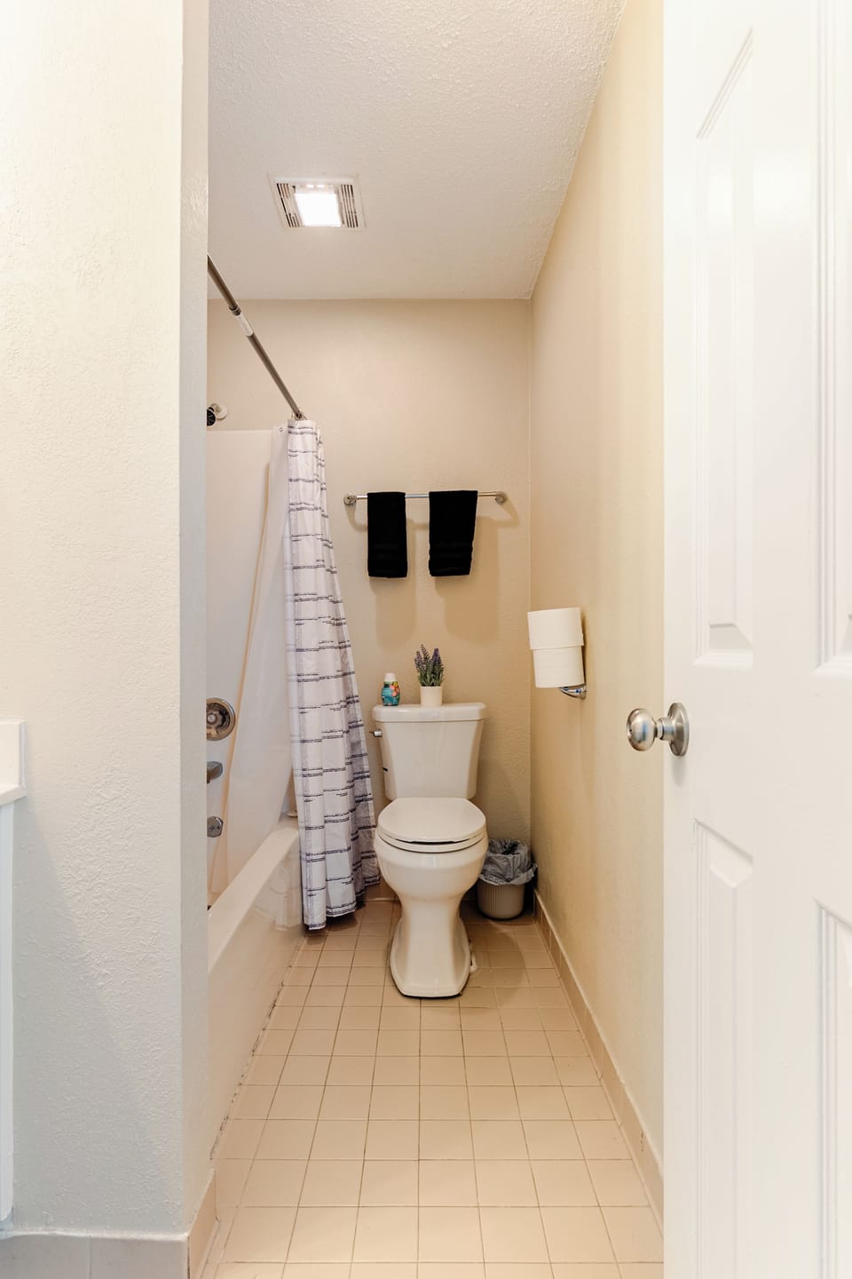 Bright, clean full bath with tub-shower combo and fresh, simple styling