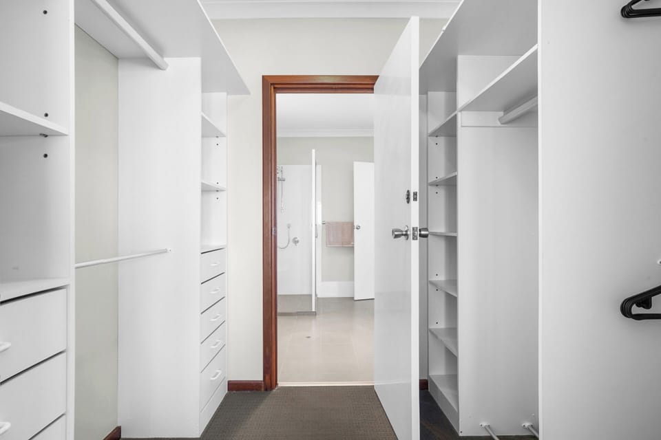 Spacious walk-in wardrobe from master bedroom.