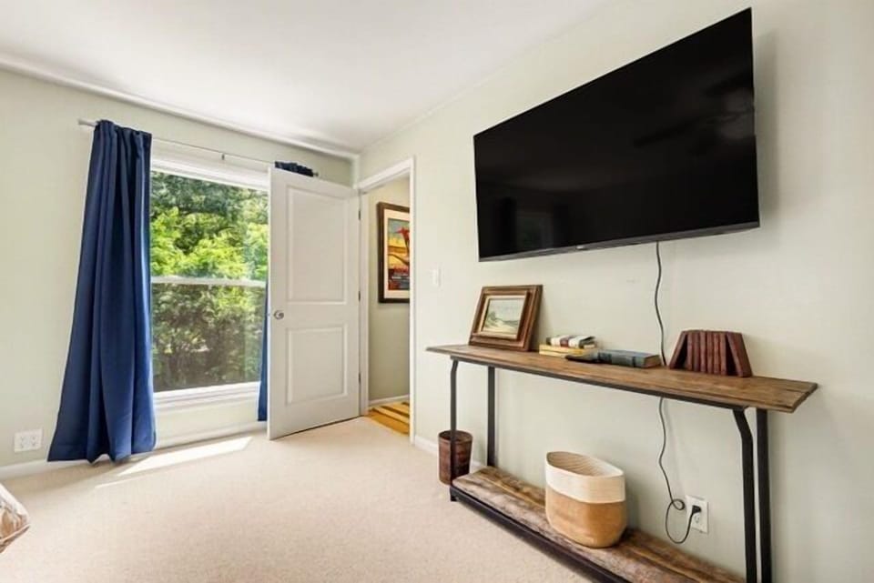 Bedroom 1- Another view with entrance to private bathroom and smart tv.