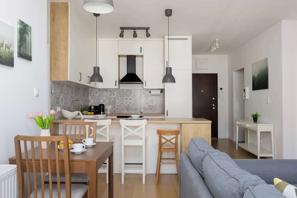 Modern open-plan kitchenette with ample storage, wooden countertops, and built-in appliances.