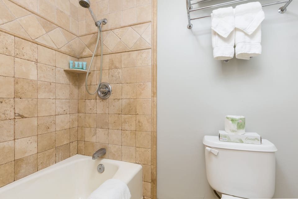 Refresh in this bright, well-appointed bathroom with a tub-shower combo and plush towels ready for you.