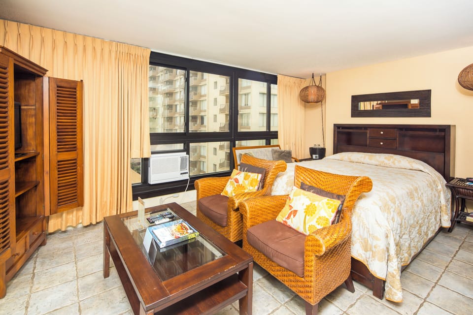 Relax in your inviting bedroom suite, where warm tropical furnishings and abundant natural light create a restful retreat after exploring the island.