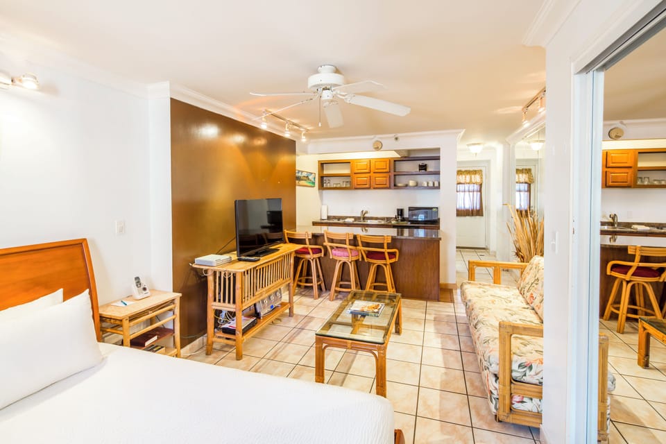 Your bright, open studio suite blends relaxed island style with thoughtful design—a cozy bed, sunny living space, and kitchen bar make this your perfect home base for unforgettable memories.