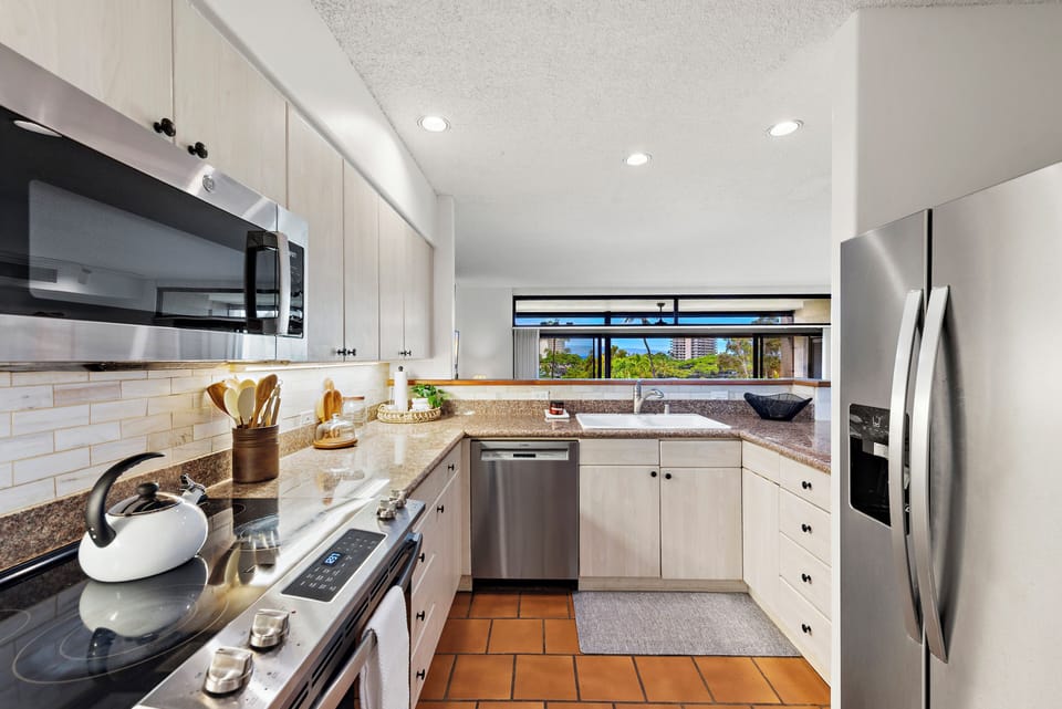 Cook and unwind in this bright, fully equipped kitchen with stainless steel appliances, granite countertops, and plenty of prep space to make your favorite meals during your stay.