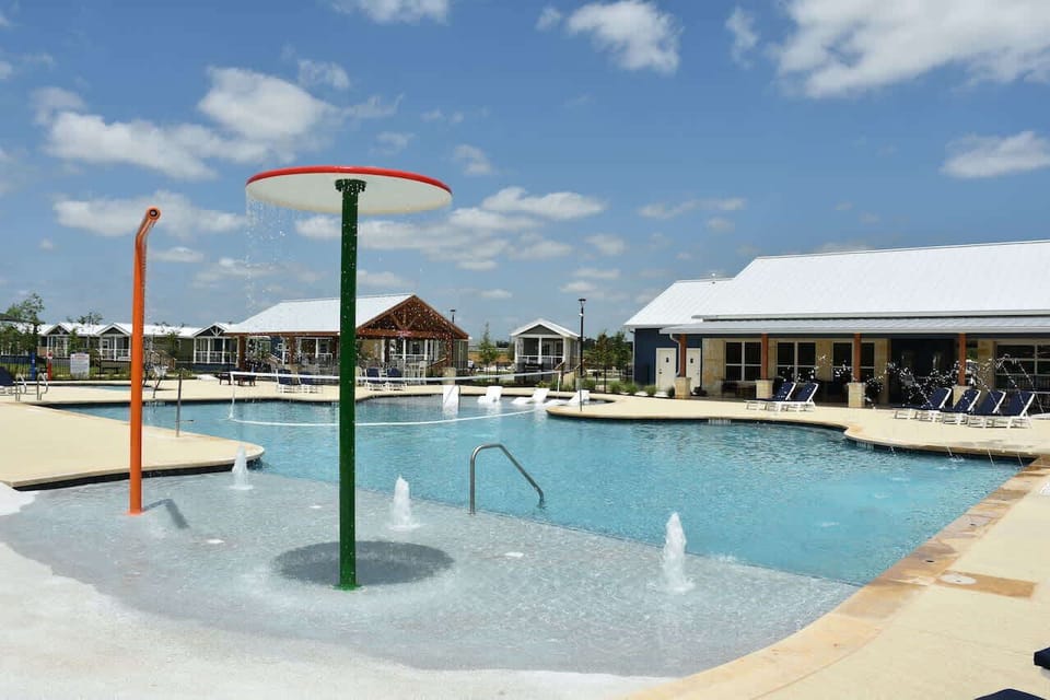 he resort-style pool with splash fountains and zero-entry beach area for the littles