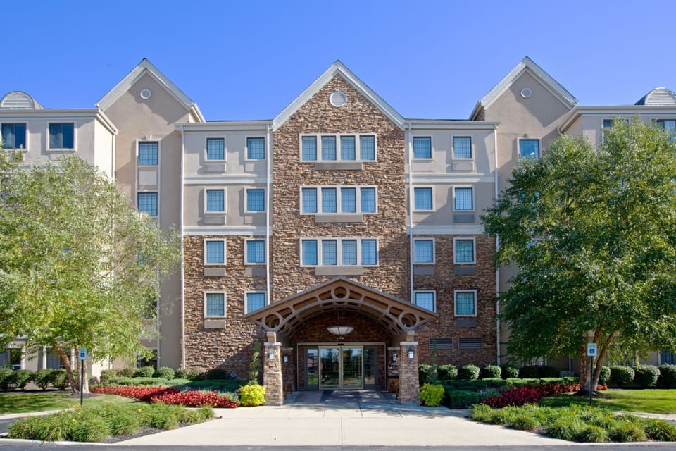 Front entrance featuring stone accents and vibrant landscaping.