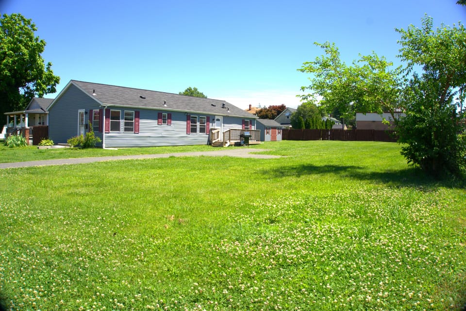 Large yard with lawn, firepit and plenty of parking