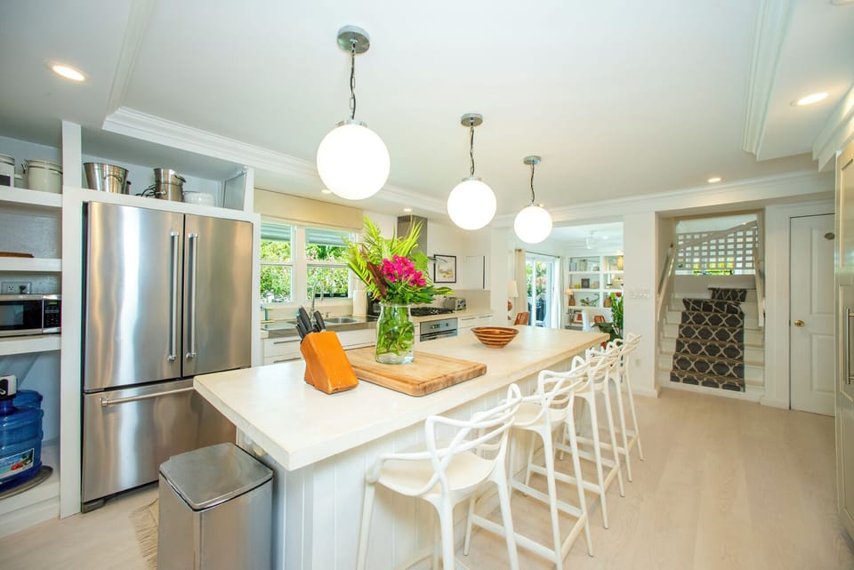 A large eight-foot island anchors the space, making it ideal for entertaining, cooking with family, or gathering while meals are prepared.