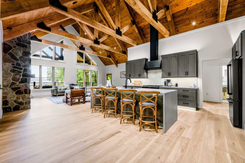 Kitchen - The gray island seats four beneath the black hood, open to the fire and the lake view.