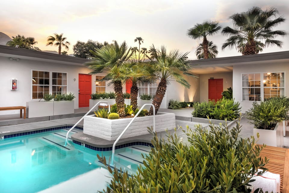 Evening poolside ambiance showcases the property’s intimate boutique layout and warm lighting.