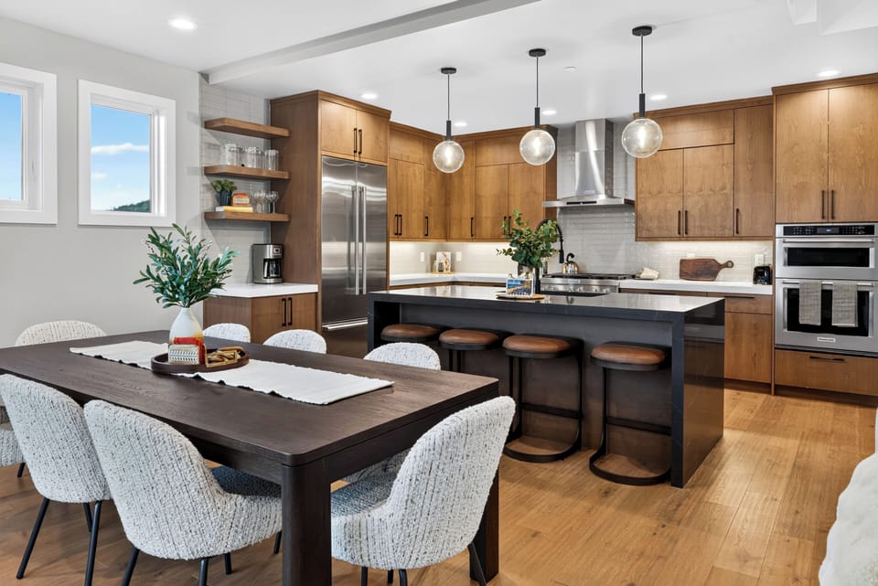 Fully equipped kitchen with a high-end gas range, premium appliances, and convenient island seating.