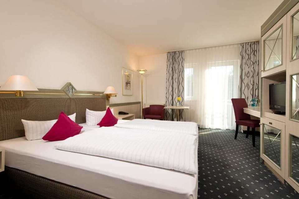 Unwind in bright twin beds with cozy sitting corner.
