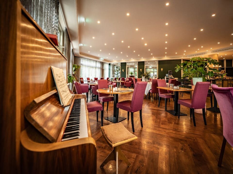 Linger over drinks in a cozy lounge with piano ambiance.