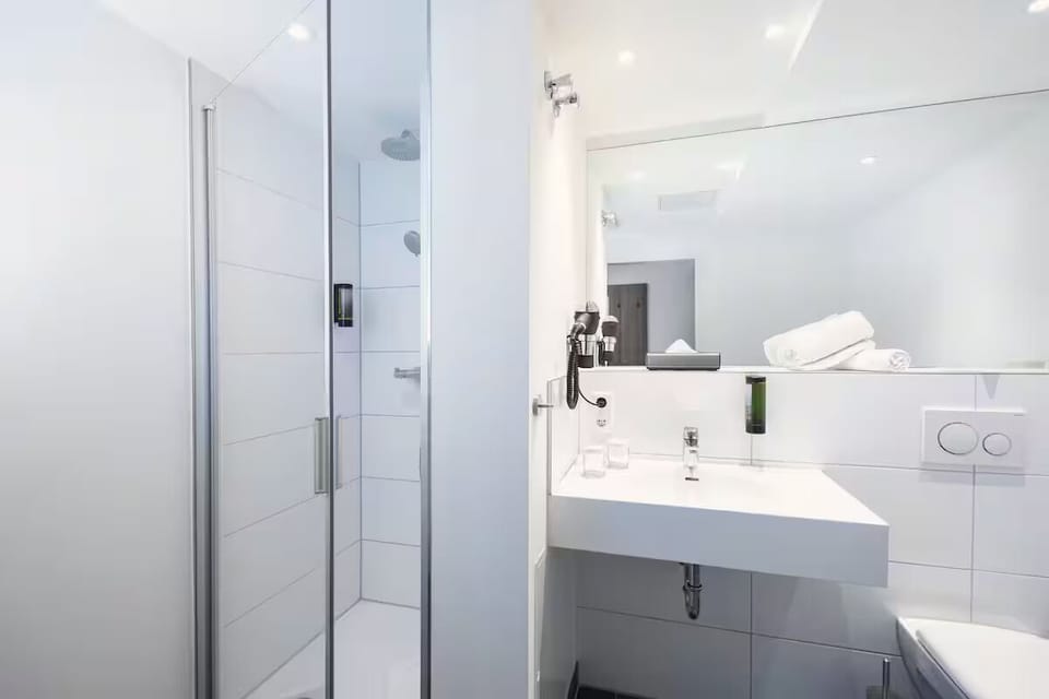Refresh under a crisp shower in a spotless, modern bath.