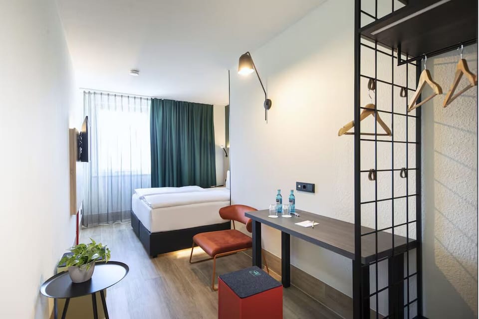 Recharge in a streamlined room with workspace and cozy seating.