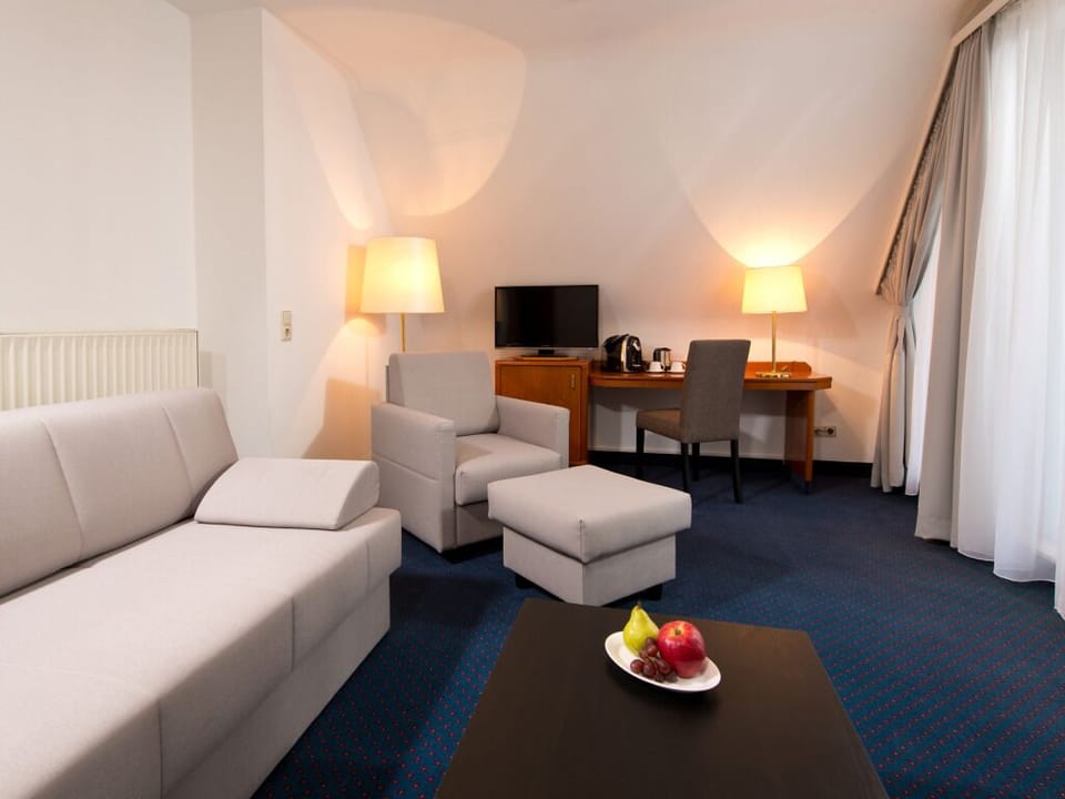 Sip coffee at the desk while relaxing in the sitting area.