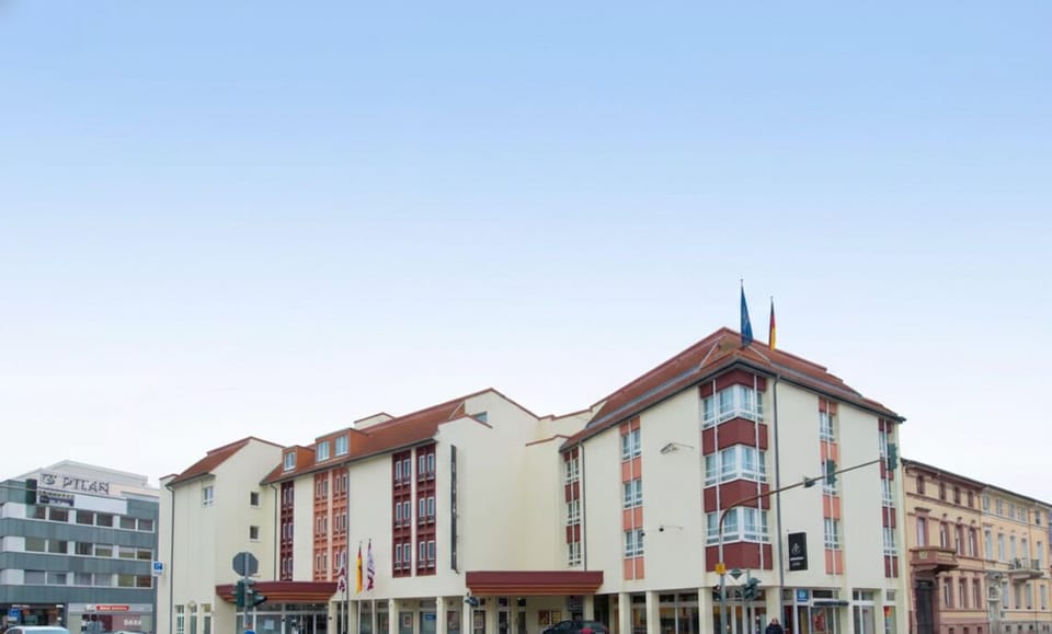Arrive confidently at a well-kept hotel façade in daylight.