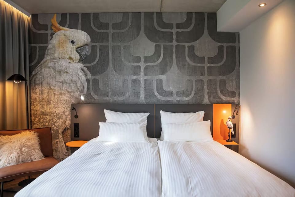 Drift off under soft lighting and striking artful wallpaper.