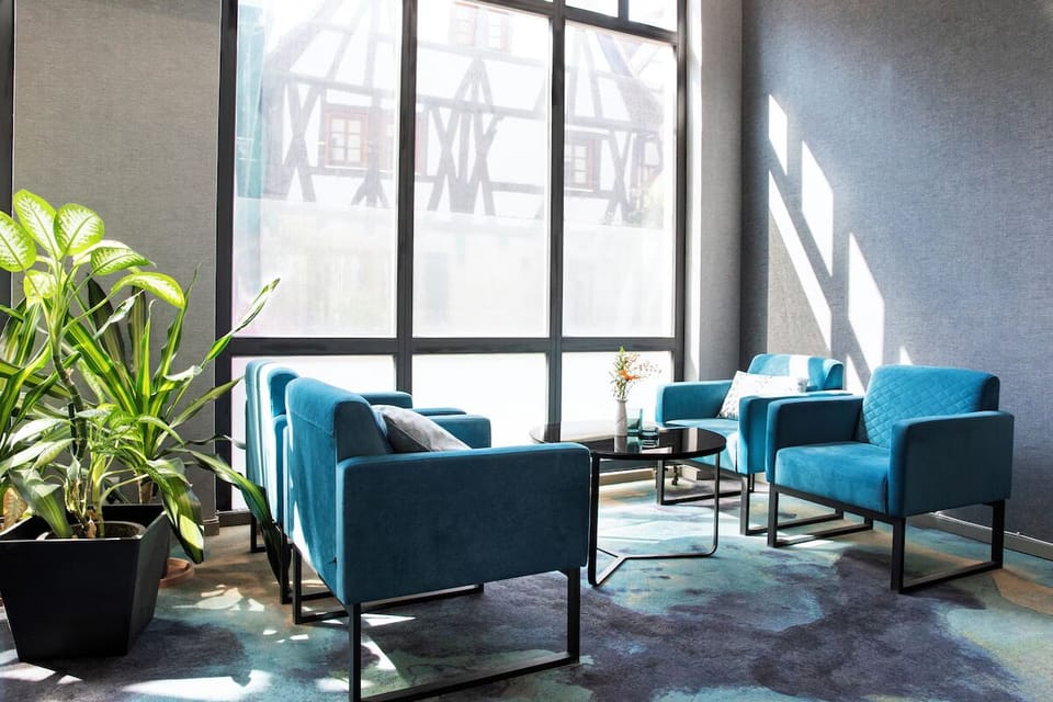 Unwind in sunlit lounge seating after a busy day.