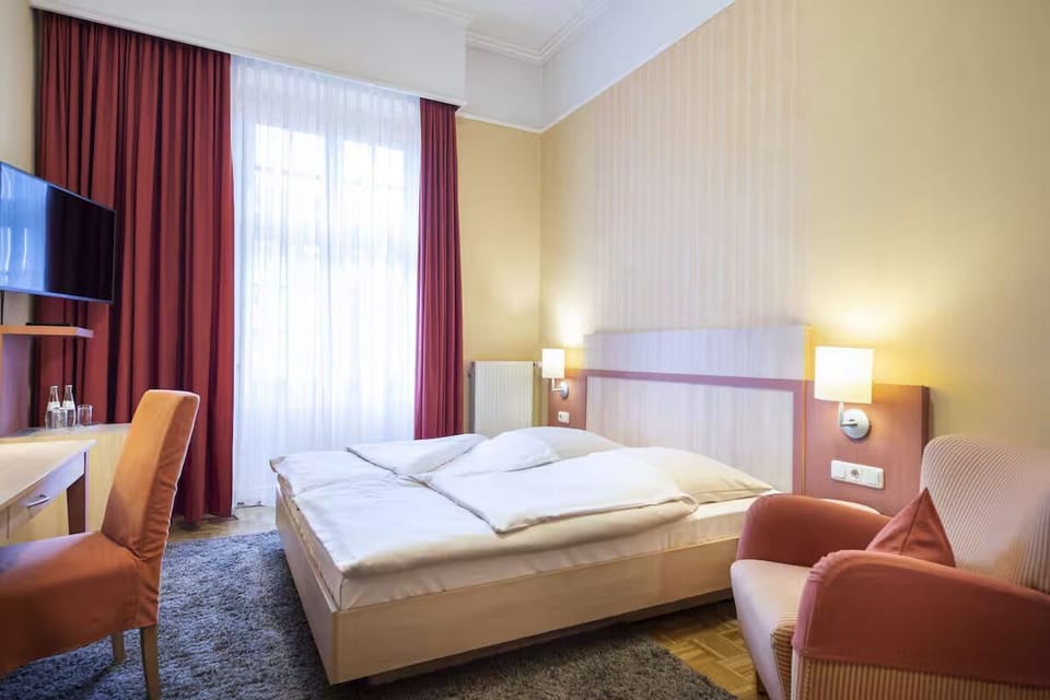 Unwind in a bright, spacious room with plush bedding.