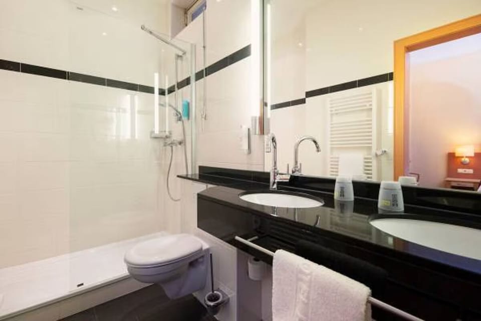 Enjoy a spotless, well-lit bath setup with plush towels