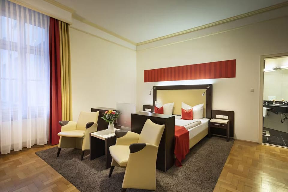 Unwind in a spacious room with cozy seating and soft light
