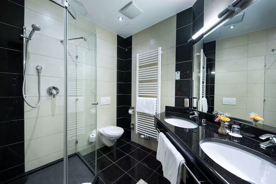Refresh in a sleek bathroom with double sinks and rain shower