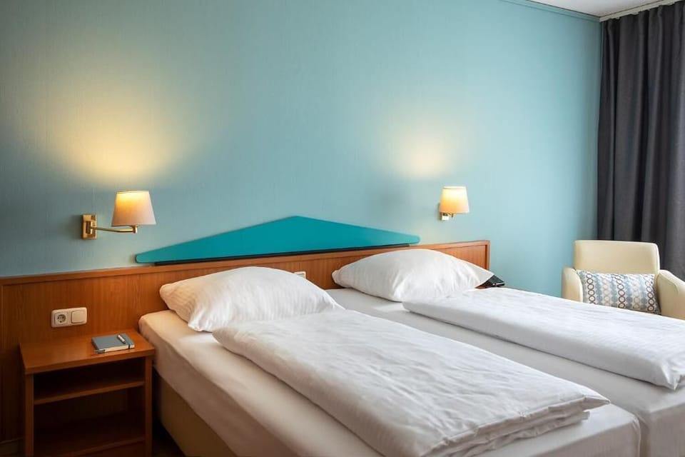 Drift off on crisp linens under warm bedside lighting.