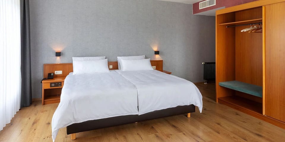 Unwind in crisp linens with a bright, restful double bed