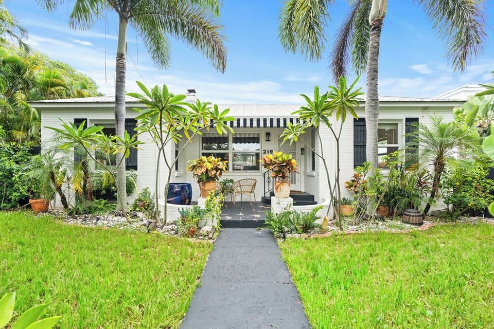 Experience a delightful blend of classic charm and lush outdoor beauty, featuring an open front lawn and a beautifully styled entrance designed to greet you in style.