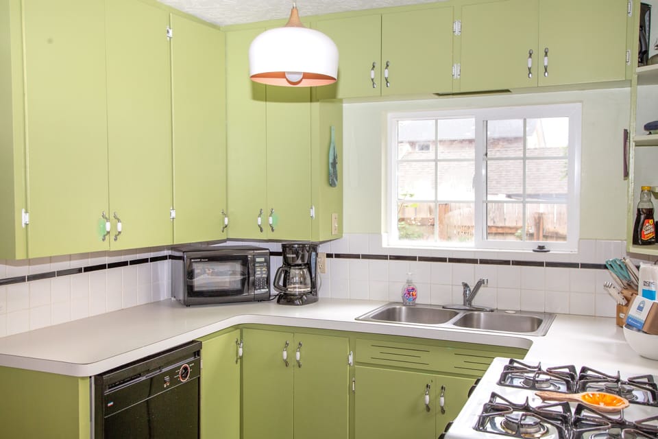 Your bright retro kitchen features a full stove, microwave, and double sink—everything you need to cook up a homemade meal during your stay.