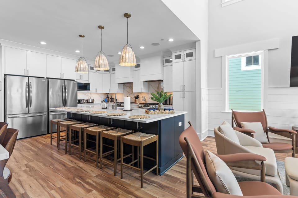 The heart of the home, with an open kitchen and oceanfront deck dining.
