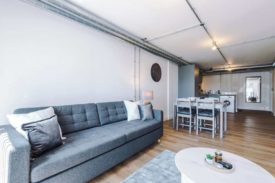 Unwind on the comfortable sofa bed in this bright, modern open-plan living area.