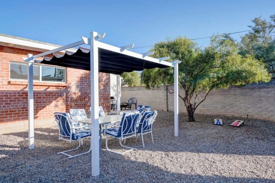 Pergola with outdoor furniture and chairs to enjoy!